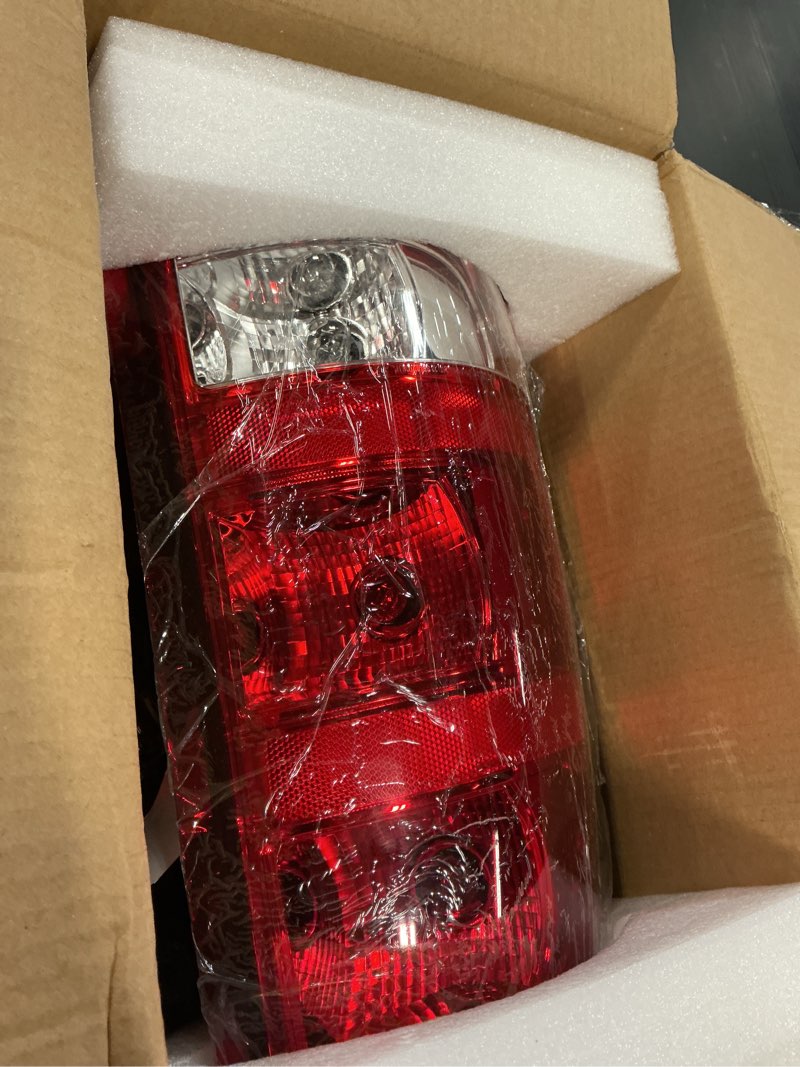 Condition photo showing As Is for tyc left tail light assembly compatible with 2004-2006 chevrolet silverado driver