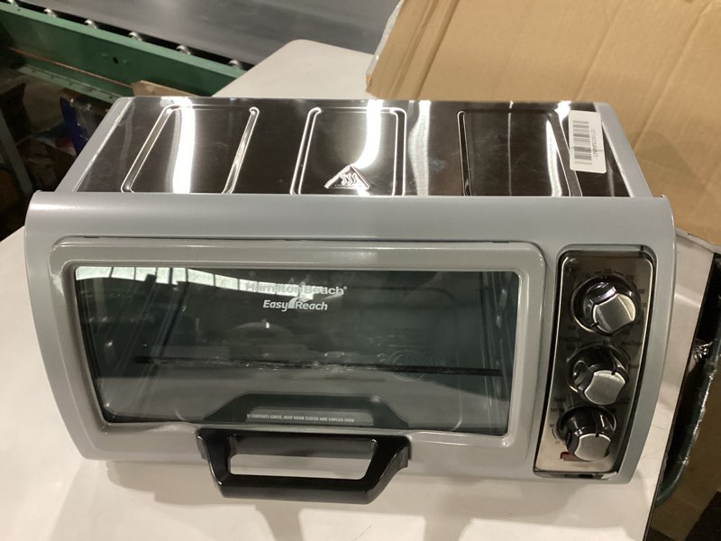 Condition photo showing As Is for *Not Tested* Hamilton Beach 6 Slice Countertop Toaster Oven With Easy Reach Roll-Top Door, Bake, Broil & Toast Functions, Auto Shutoff, Silver (31127D) missing Rack