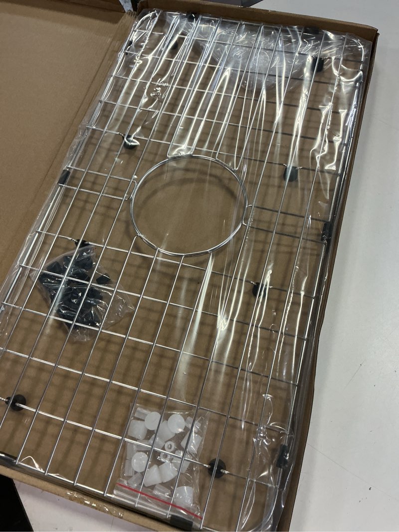 Condition photo showing Good Condition for serene valley sink bottom grid 24-1/8" x 12-5/8", centered drain with corner radius 1-1/2", sink protector nlw2412c