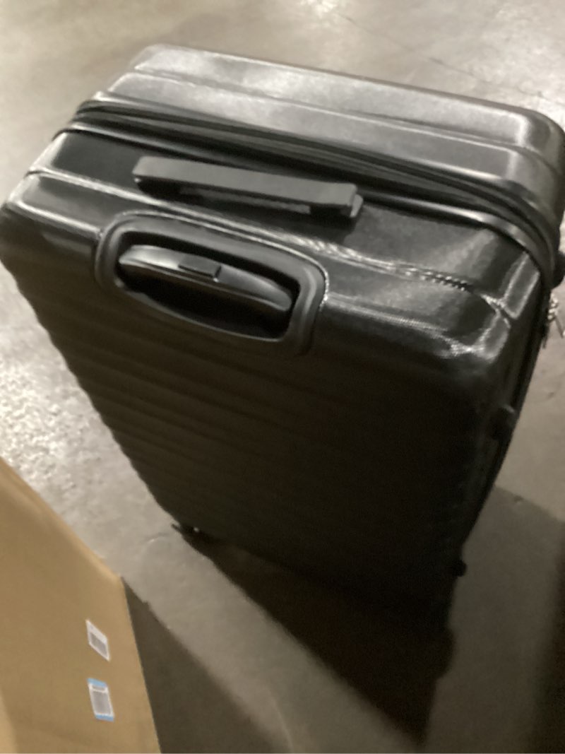 Condition photo showing As Is for amazon basics 30" hardside large checked luggage, hardshell suitcase with wheels, expandable for up to 15% more space, with scratch-resistant surface, four multi-directional wheels, black black large checked