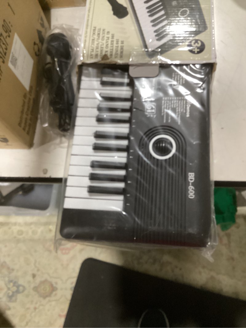 Condition photo showing As Is for 61 key portable electronic keyboard piano w/lighted full size keys, lcd, headphones, x-stand, stool, music rest, microphone, note stickers, built-in speakers,3 teaching modes
