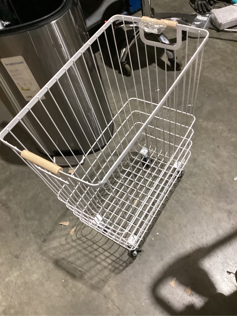 Condition photo showing As Is for wire rolling laundry hamper - brightroom™