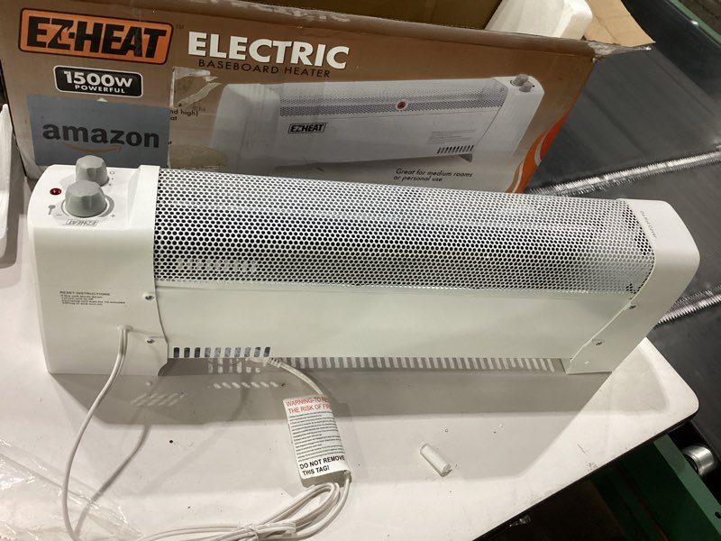 Condition photo showing As Is for ez-heat 1,500 watt baseboard space heater with adjustable thermostat, dent-proof end panels, overheat protection, tip-over switch, & stay-cool body, cz600
