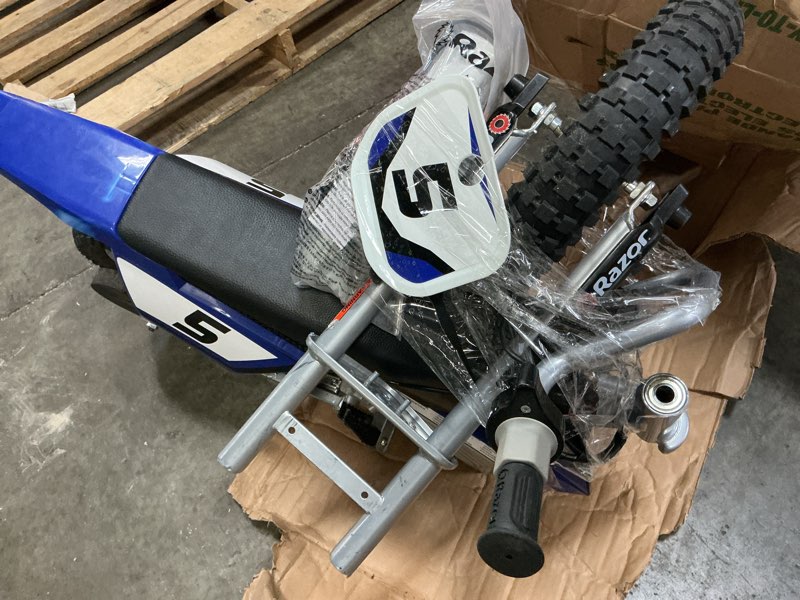 Condition photo showing As Is for razor mx350 dirt rocket electric bike for kids ages 8+, 140 lb max weight, blue – 24v battery, up to 14 mph, 30-min ride time on high speed, twist-grip throttle, spoked wheels w/ 12” pneumatic tires rear braking mx350 - blue