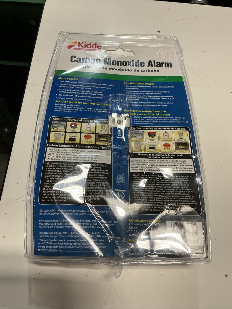 Condition photo showing As Is for kidde carbon monoxide detector, plug in wall with aa battery backup, test-hush button clamshell packaging
