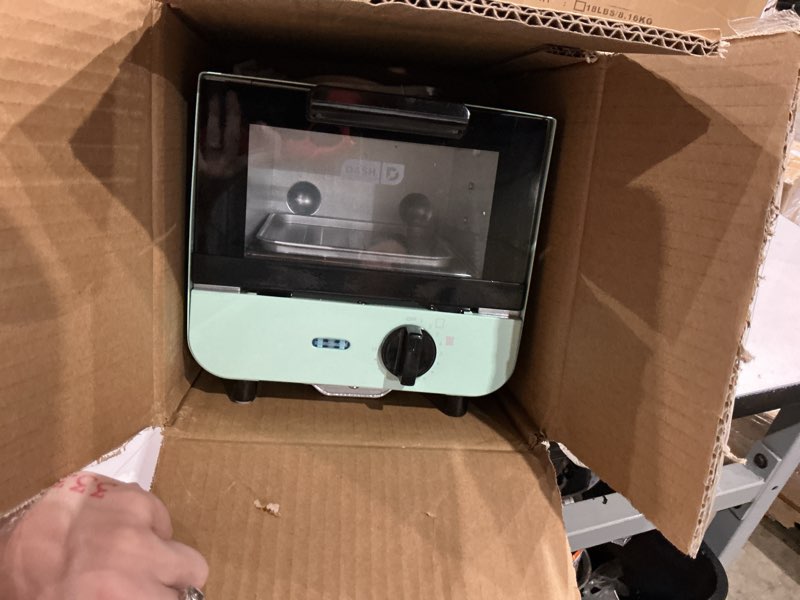 Condition photo showing As Is for dash mini toaster oven | small toaster oven for dorms, apartments, & small kitchens, adjustable timer dial with auto shutoff, removable cooking tray & crumb catch, aqua aqua cooker