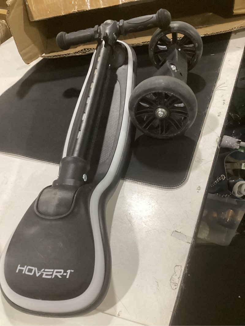 Condition photo showing As Is for hover-1 chroma folding kick scooter for kids with multicolor wheel lights, 3” front wheels, rear foot brake, and 110 lb weight capacity black
