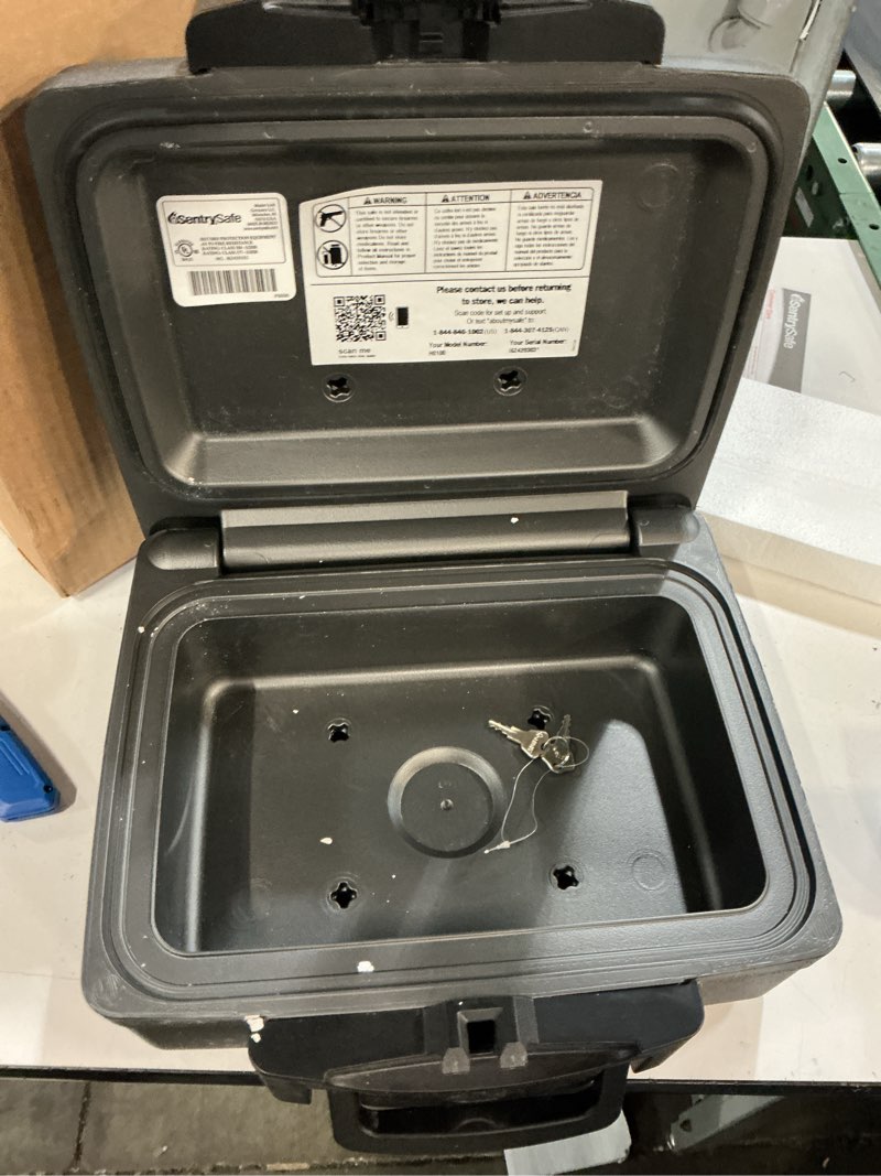 Condition photo showing New/Like New for sentrysafe fireproof and waterproof safe, black portable lock box with key lock and carrying handle for money, passport, exterior: 14.3 in w x 13 in d x 6.1 in h, ?h0100
