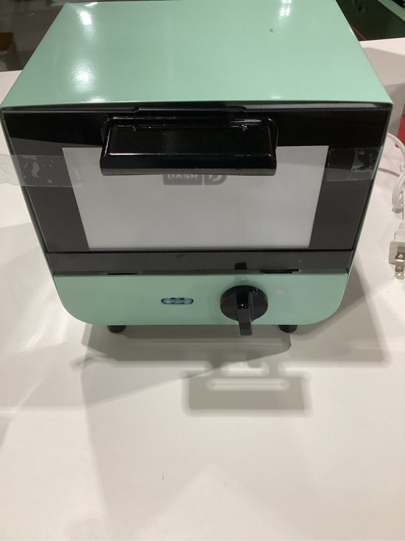 Condition photo showing New/Like New for DASH Mini Toaster Oven Cooker for Bread, Bagels, Cookies, Pizza, Paninis & More with Baking Tray, Rack, Auto Shut Off Feature - Aqua Aqua Cooker, NOT TESTED