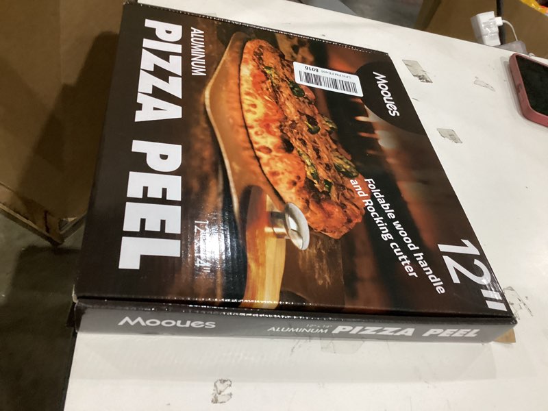 Condition photo showing New/Like New for Pizza Peel Aluminum Pizza Spatula, Mooues 12 inch Metal Pizza Paddle(12"x 14")with Rocker Cutter Foldable Wood Handle, [Storage bag included], for Family Pizza Oven Baking Pizza, Dough, Bread & Pastry Pizza Peel 12"x 14" with Rocker Cutter