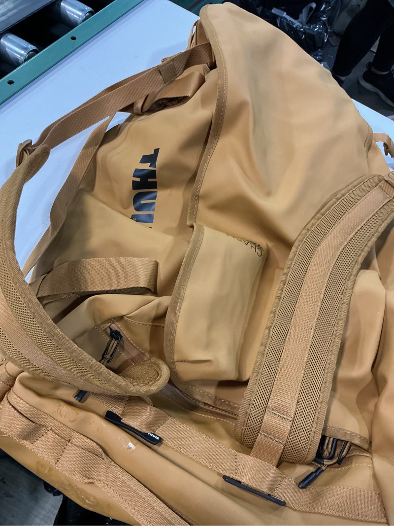 Condition photo showing Good Condition for thule chasm duffel bag, weather-resistant materials, easy packing, converts to backpack, internal pockets, travel-ready 70l golden brown
