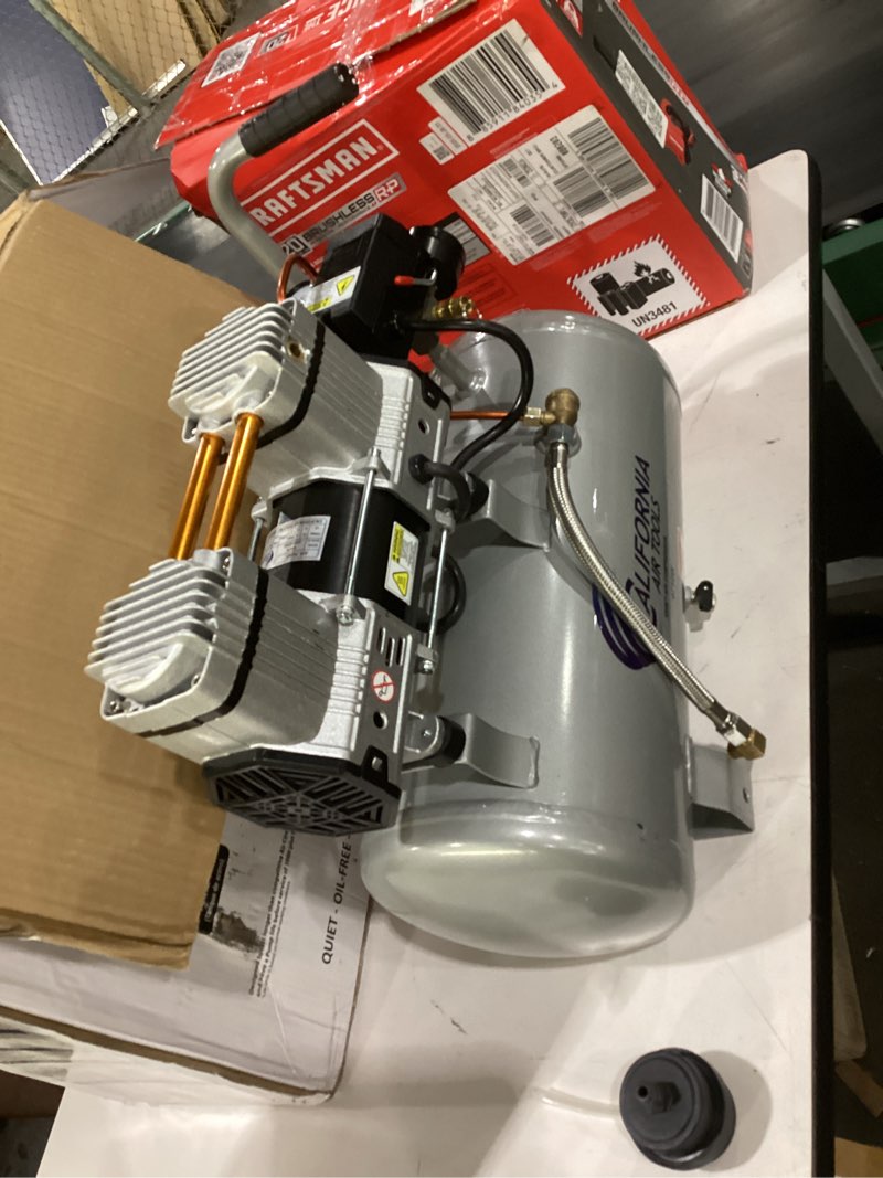 Condition photo showing As Is for california air tools cat-4710w 1.0 hp quiet and oil-free air compressor with wheels, 4.7 gallon steel tank, 75 dba noise level, lightweight 4.7 gallon steel, wheels