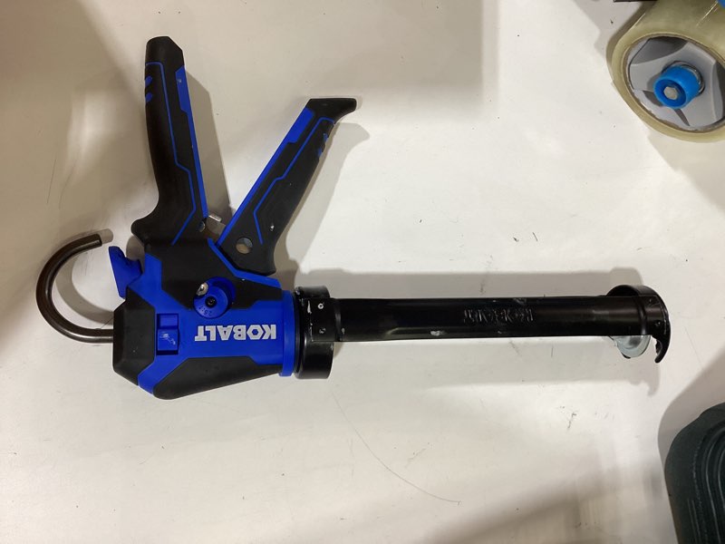 Condition photo showing As Is for kobalt dual thrust 10 -oz anti-drip smooth rod caulk gun