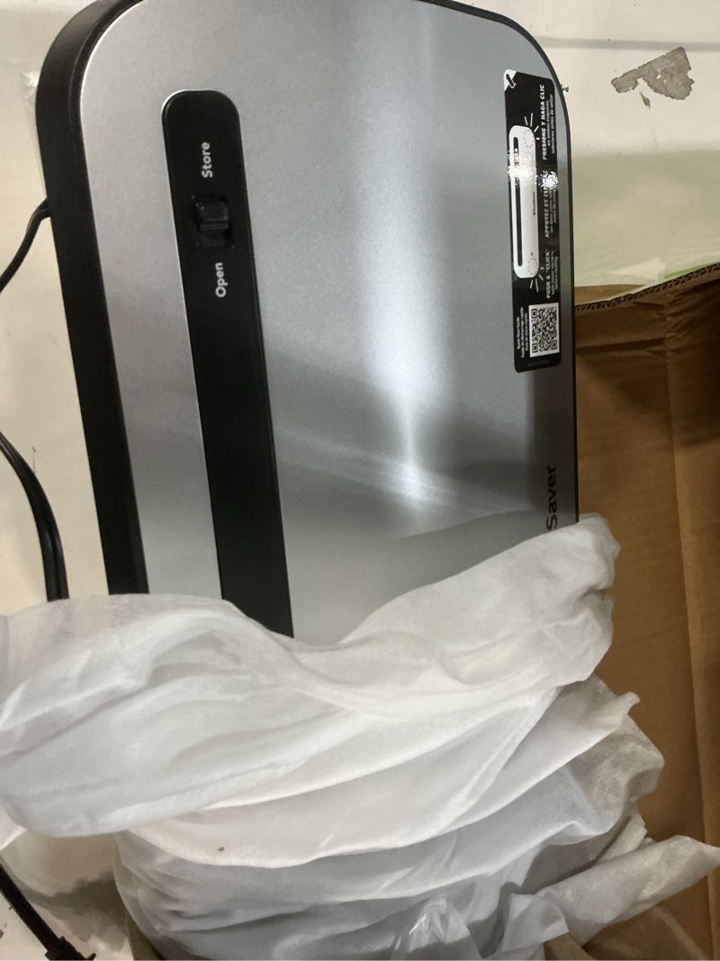 Condition photo showing As Is for foodsaver space-saving vacuum sealer with bags and roll