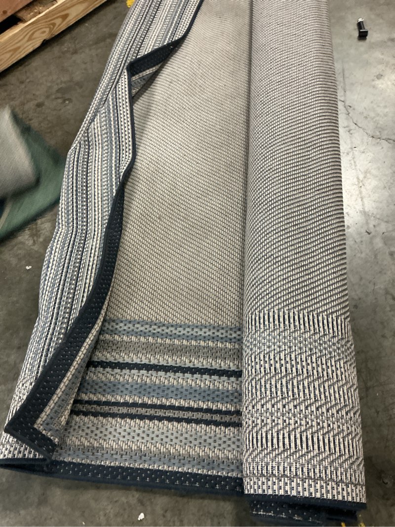 Condition photo showing As Is for stainmaster blue border 8 x 10 (ft) loomed polypropylene blue rectangular