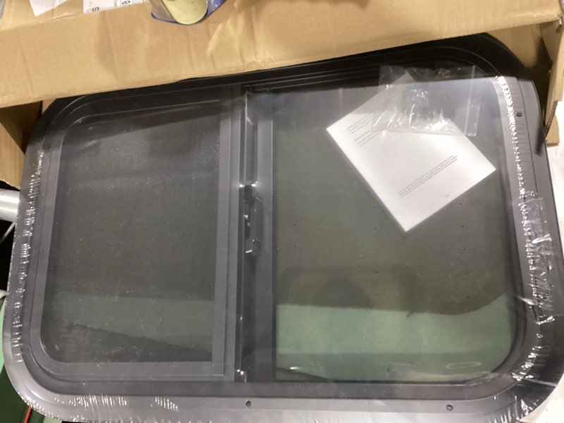 Condition photo showing New/Like New for horizontal rv window, 21" w x 14" h tinted sliding rv window with net screen and trim ring, suitable for 15/16" or 1-3/8" and slightly thicker up to 1/16" walls, dot approved 21x14in 1