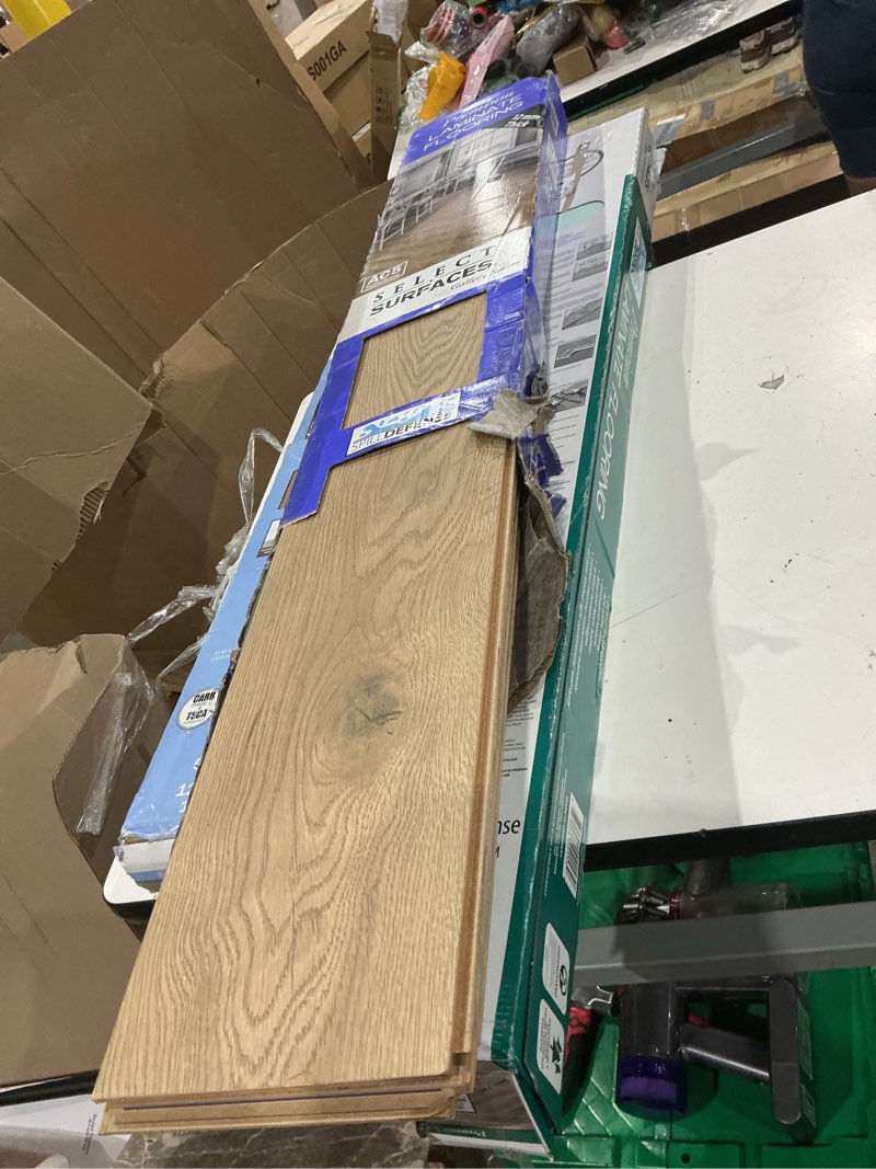 Condition photo showing As Is for select surfaces victoria spilldefense laminate flooring, 17.49 sq. ft. per box