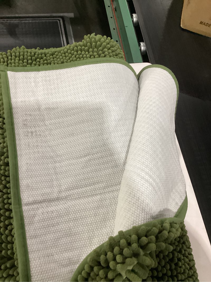 Condition photo showing As Is for green rug