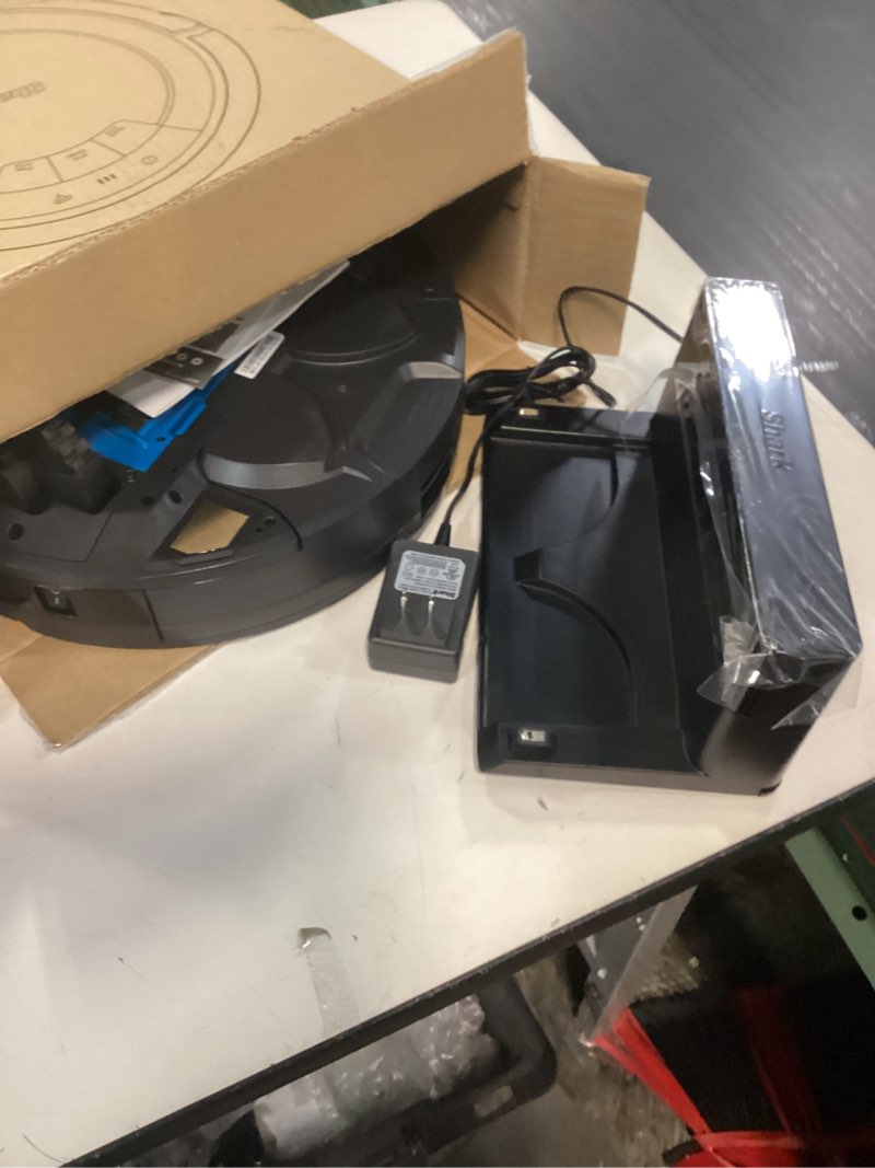Condition photo showing As Is for Shark AV753 ION Robot Vacuum, Tri-Brush System, Wifi Connected, 120 Min Runtime, Works with Alexa, Multi Surface Cleaning, Grey ION Robot (Grey)