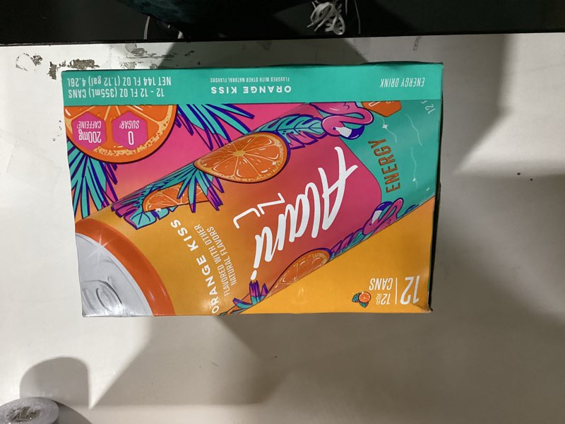 Condition photo showing New/Like New for alani nu orange kiss, sugar free, low calorie energy drinks, 200mg caffeine, biotin, b vitamins, zero sugar, 10 calories, 12 fl oz cans, 12 pack orange kiss 12 fl oz (pack of 12)