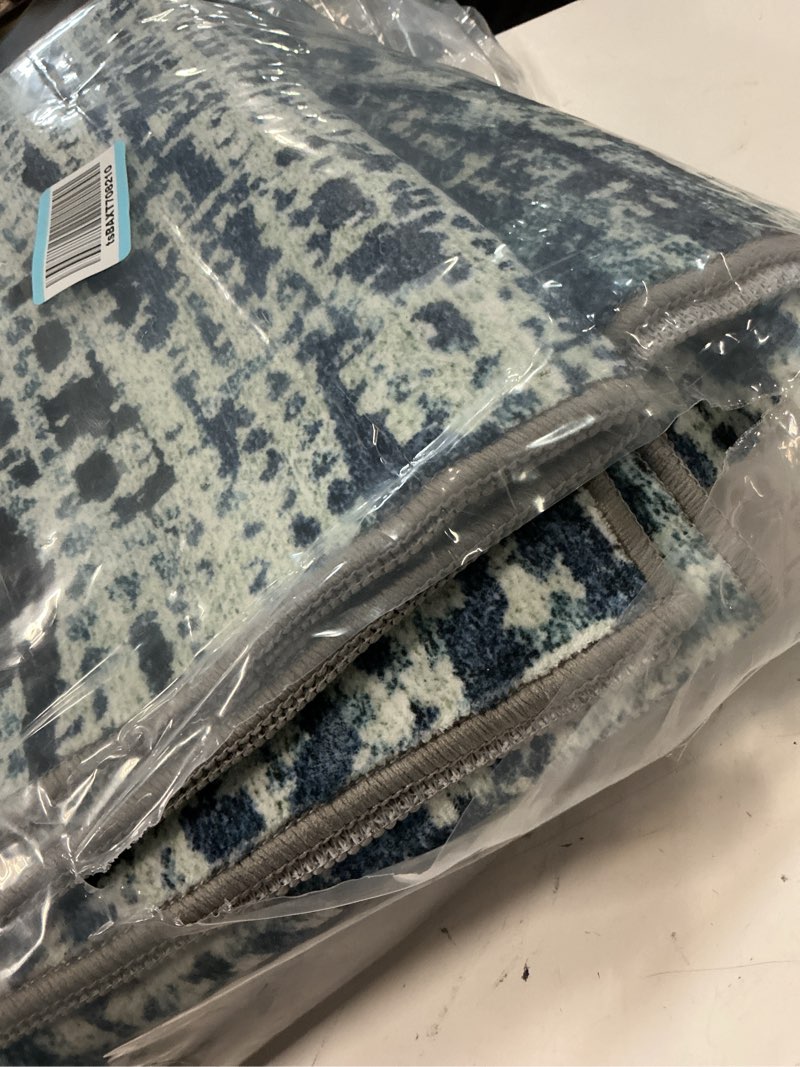Condition photo showing As Is for washable area rug - 1/6" thick low-pile - stain & water resistant non-slip backing - pet & child friendly vintage speckled design in grey with light teal & white accents (8' x 10') depth-grey+lightteal 8' x 10' (rectangular)
