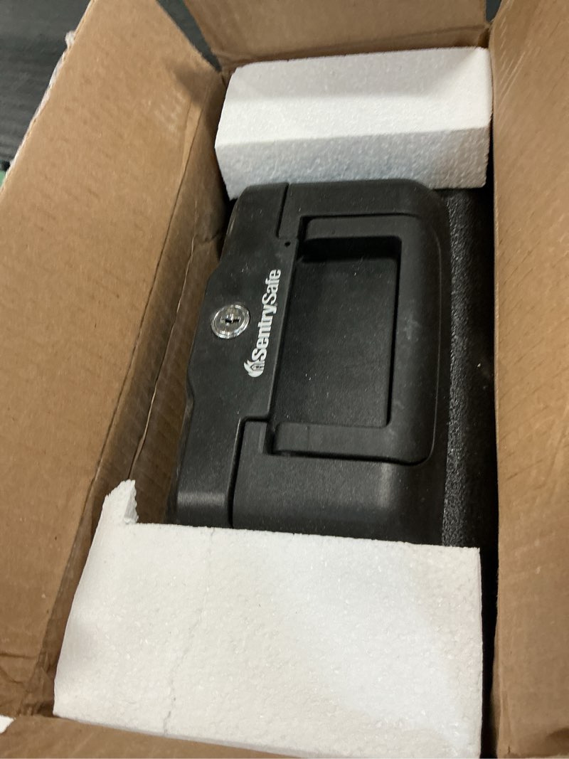 Condition photo showing As Is for SentrySafe Fireproof Money Safe with Key Lock, Black Lock Box with Portable Carrying Handle for Travel, Exterior: 14.3 in. W x 11.2 in. D x 6.1 in H, 1200 Fire resistant box 0.18 cu. ft.