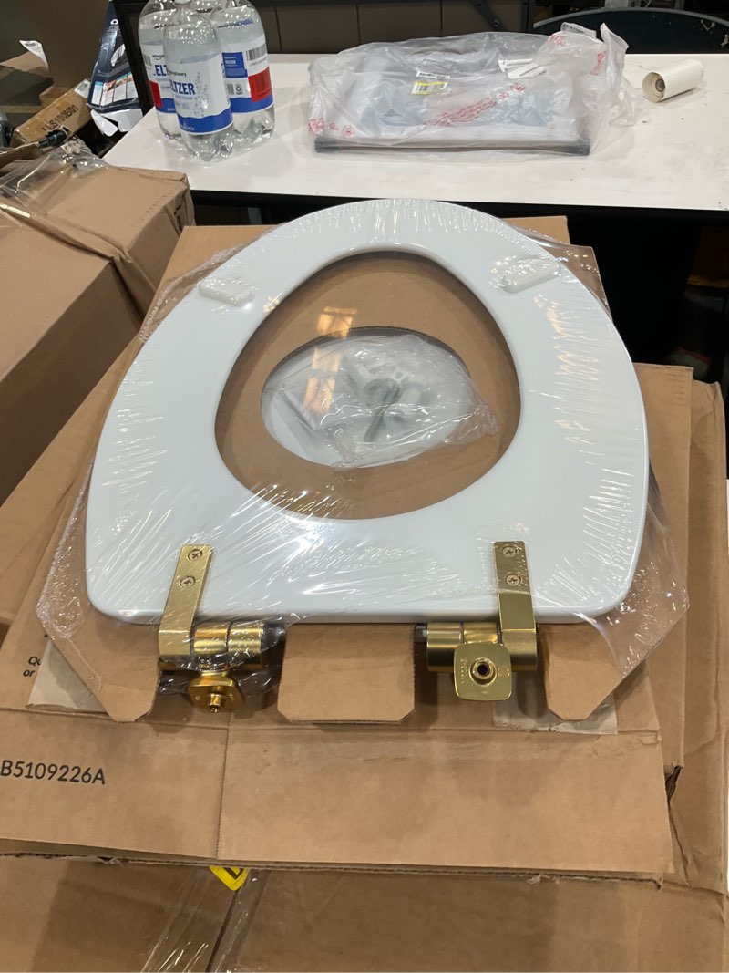 Condition photo showing New/Like New for mayfair bennett toilet seat with brushed gold hinges, slow close wood seat, secure metal hinges, easy install, made in usa, elongated, white elongated gold