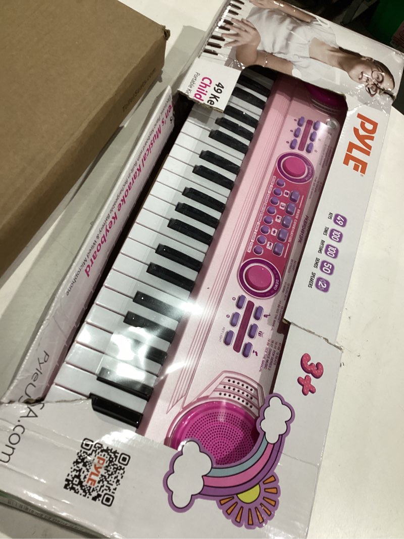 Condition photo showing Good Condition for Pyle Electric Keyboard 49 Keys – Portable Digital Piano with 100 Rhythms, 100 Tones, 50 Demo Songs, Rechargeable Battery, Wired Microphone – Beginner Keyboard for Kids and Adults, Pink (PKBRD4912PK.3) Girls 50 Demos