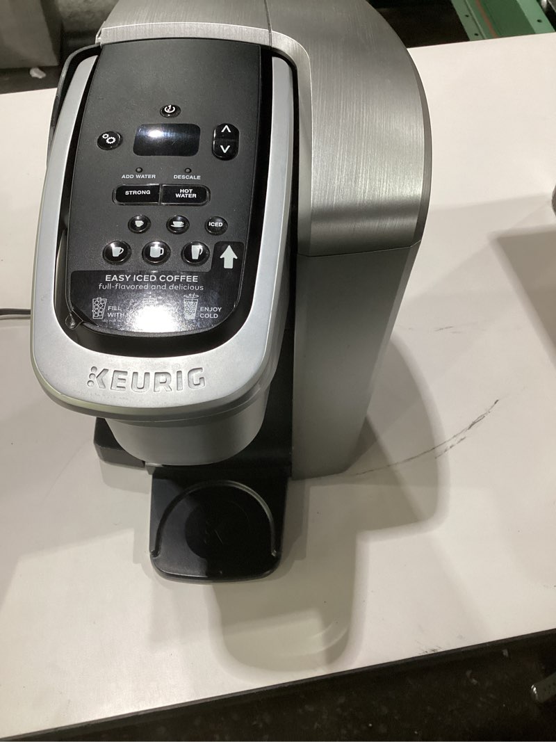 Condition photo showing As Is for Keurig K-Elite Single Serve K-Cup Pod Coffee Maker, with Strength and Temperature Control, Iced Coffee Capability, 8 to 12oz Brew Size, Programmable, Brushed Silver, NOT TESTED, AS IS, MISSING PART 
