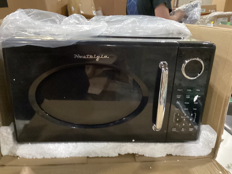 Condition photo showing As Is for Not tested ***Nostalgia Retro 1000W Microwave Oven 1.1 Cu Ft Capacity – Child Safety Lock, 8 Auto-Cook Settings – Countertop Kitchen Appliance – Black Retro 1.1 Cu. Ft. Black