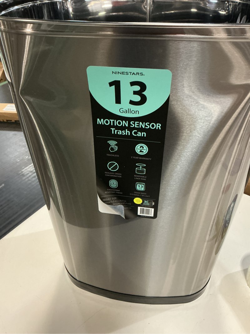 Condition photo showing As Is for nine stars 13.2 gallon trash can, motion sensor kitchen trash can, stainless steel