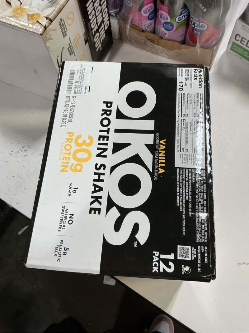 Condition photo showing New/Like New for ( BB :06/2027)Oikos Protein Shake, Vanilla, 30g High Protein Drinks, Shelf Stable, Ready to Drink, 5g Prebiotic Fiber, 12 fl oz Bottle, 12 Count? Vanilla 12 Fl Oz (Pack of 12)