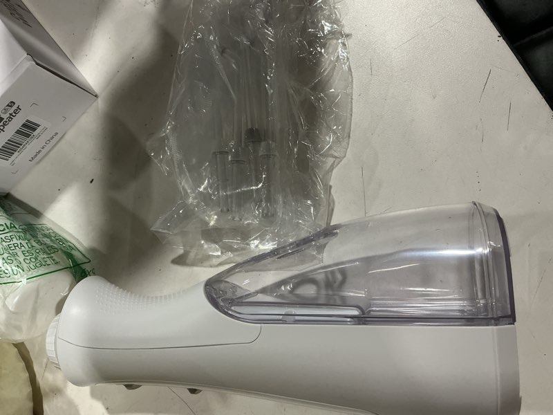 Condition photo showing As Is for waterpik cordless pearl rechargeable portable water flosser for teeth, gums, braces care and travel, extra quiet, 4 flossing tips - ada accepted, wf-13 white, amazon exclusive pearl white