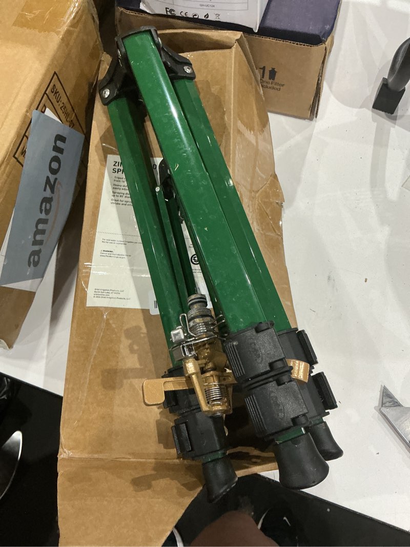 Condition photo showing As Is for orbit tripod lawn zinc impact sprinkler - 360 degree rotating yard sprinkler with adjustable height - heavy-duty zinc - high-pressure nozzle - for large lawn coverage - 56667