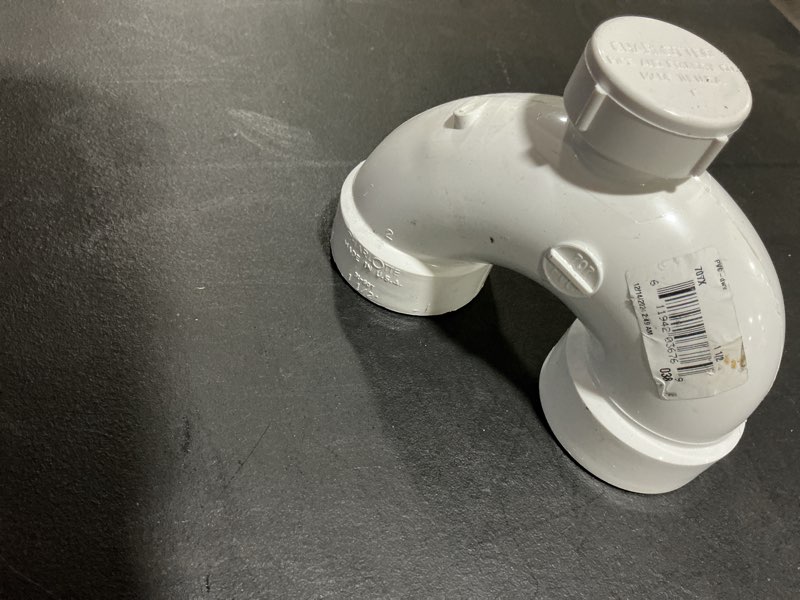 Condition photo showing As Is for 1 1/2 in. dwv pvc p- trap with solvent weld joint