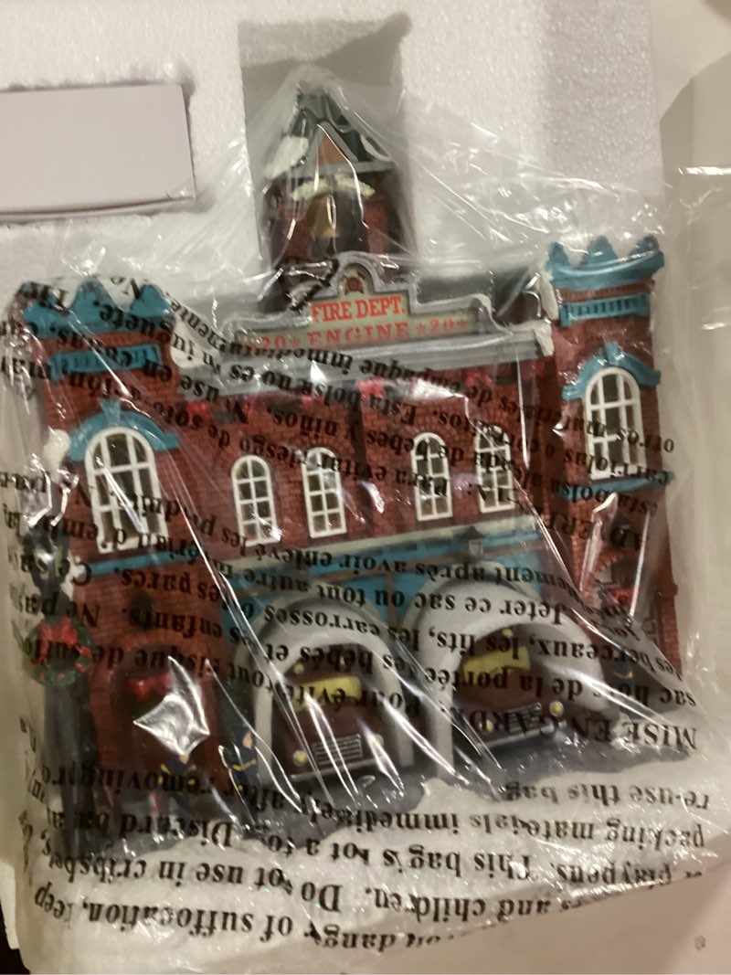 Condition photo showing item condition for MOMENTS IN TIME Vintage Fire Department Christmas Village 12.2” LED Lights, Music & Moving Fire Trucks, Polyresin Lighted Holiday Building, Adapter Operated Holiday Decoration 21217