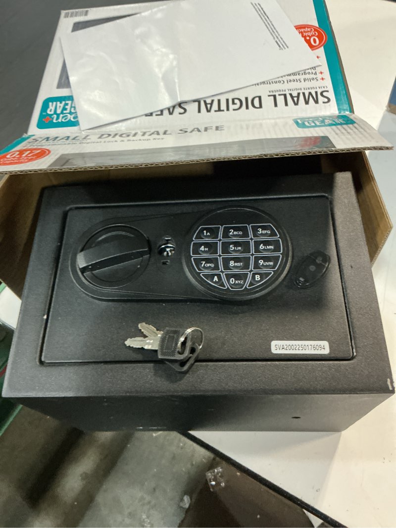 Condition photo showing As Is for pen + gear small digital safe with electronic lock and backup key in black model 17scm