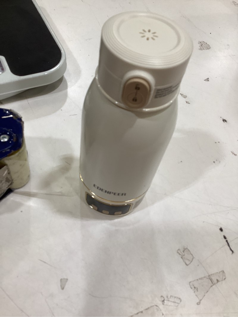 Condition photo showing As Is for the item shown is an edenpeer portable bottle warmer, designed for heating formula or breast milk while on the go.  