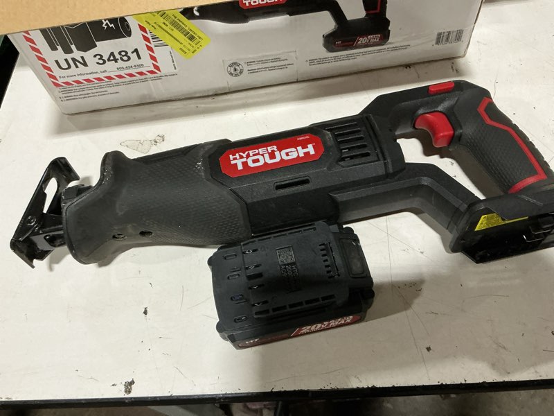 Condition photo showing As Is for hyper tough 20v max lithium-ion cordless reciprocating saw, variable speed, keyless blade change, with 1.5ah lithium-ion battery and charger, wood blade and led light