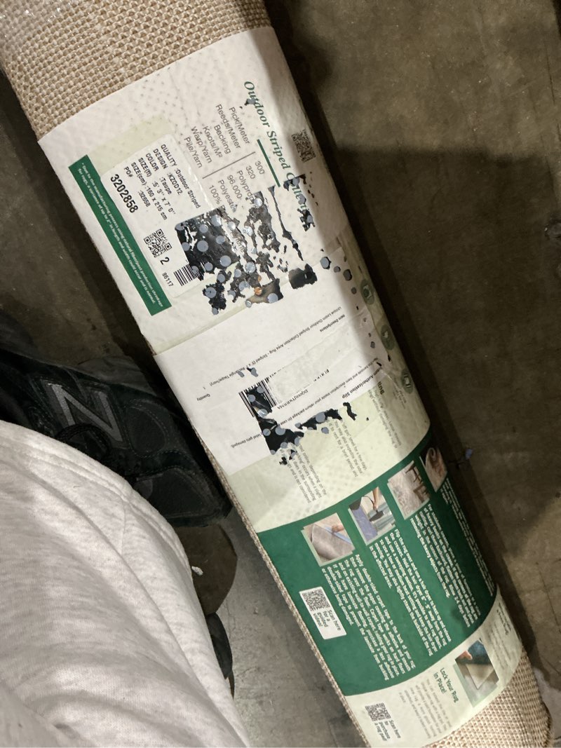 Condition photo showing Good Condition for  easy-clean striped indoor / outdoor rug pick/meter  300  reeds/meter  320  backing  polypropy  knots/m²  96.000.  warp/yarn  polyeste  pile/yarn  100%  quality : outdoor striped  design :kzod12  color taupe  size(11) 5' 3" x 7' 0"  size(cm):160 x 215 cm  po  32658  3202858