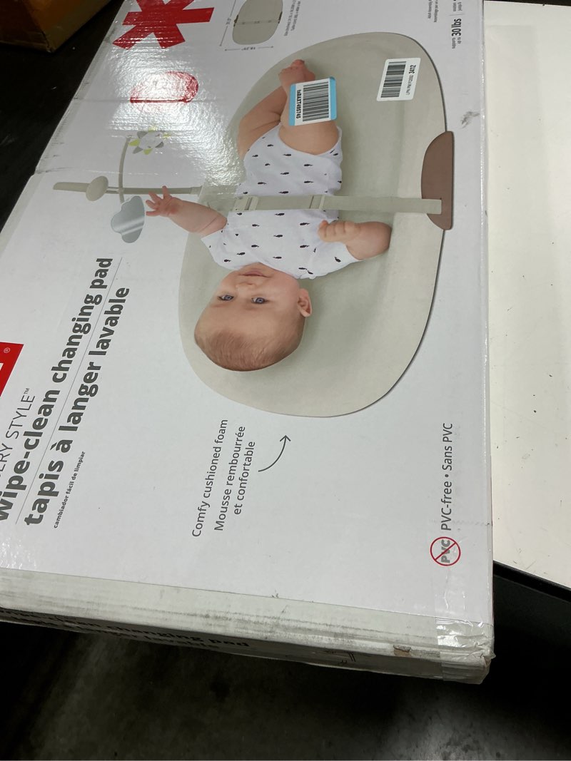 Condition photo showing New/Like New for skip hop baby changing pad nursery style wipe-clean contoured with cushioned foam, non-skid base, built-in safety belt & tuck-away toy bar, oat 18" oat