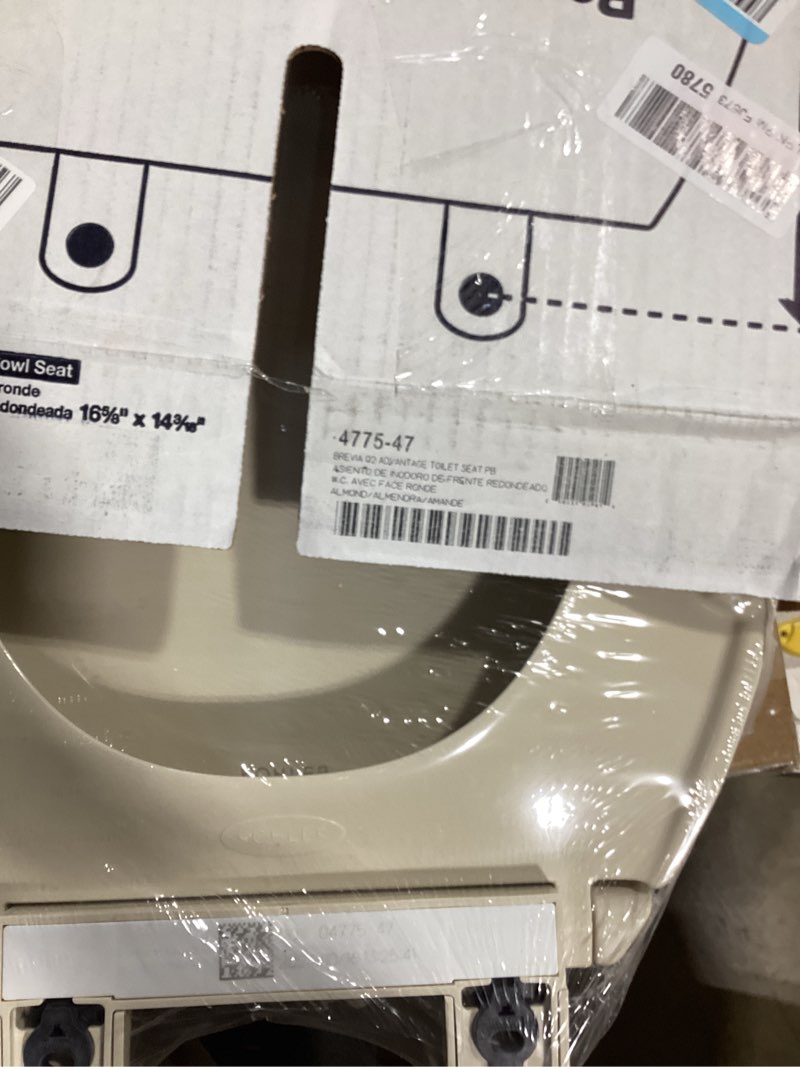 Condition photo showing New/Like New for kohler k-4775-47 brevia round toilet seat with quick-release hinges and quick-attach hardware for easy clean, almond round almond