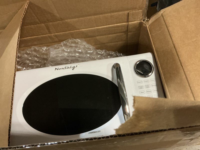 Condition photo showing As Is for Nostalgia Retro Microwave Oven - 0.7 Cu Ft, 700-Watt Countertop Size with Glass Turntable, Child Safety Lock, 8 Auto-Cook Programs, Digital Clock - White Retro 0.7 Cu. Ft. White