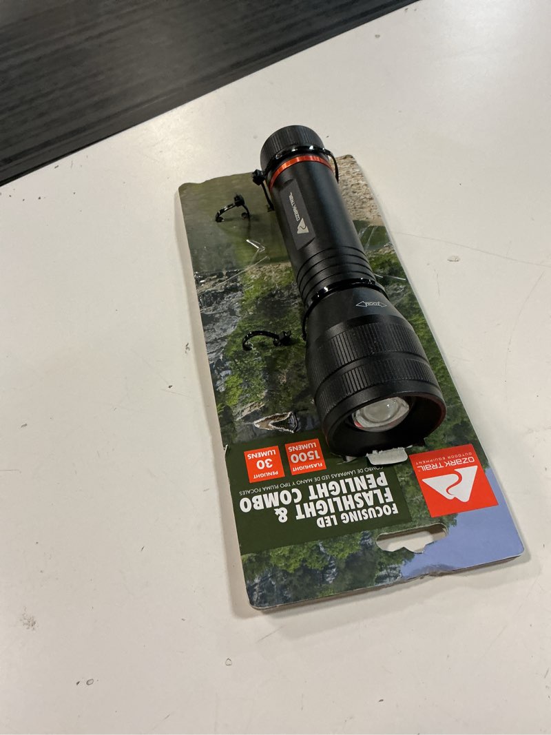 Condition photo showing As Is for ozark trail 1500 lumen focusing flashlight with bonus penlight, waterproof, black