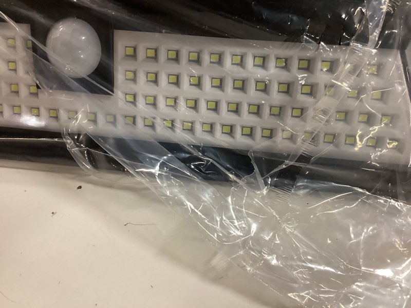 Condition photo showing As Is for magnetic solar rv light with motion sensor, 118 led ultra bright exterior rv light, 2400mah battery, easy install with 2 strong magnets, waterproof camper & truck outdoor porch lighting