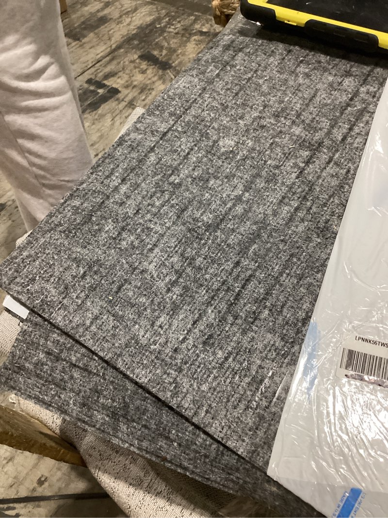 Condition photo showing As Is for mohawk home 24" x 24" indoor/outdoor 0.25" pile height, peel and stick carpet tile, grey polyester, (15 tiles) (60 sqft/box) graphite grey