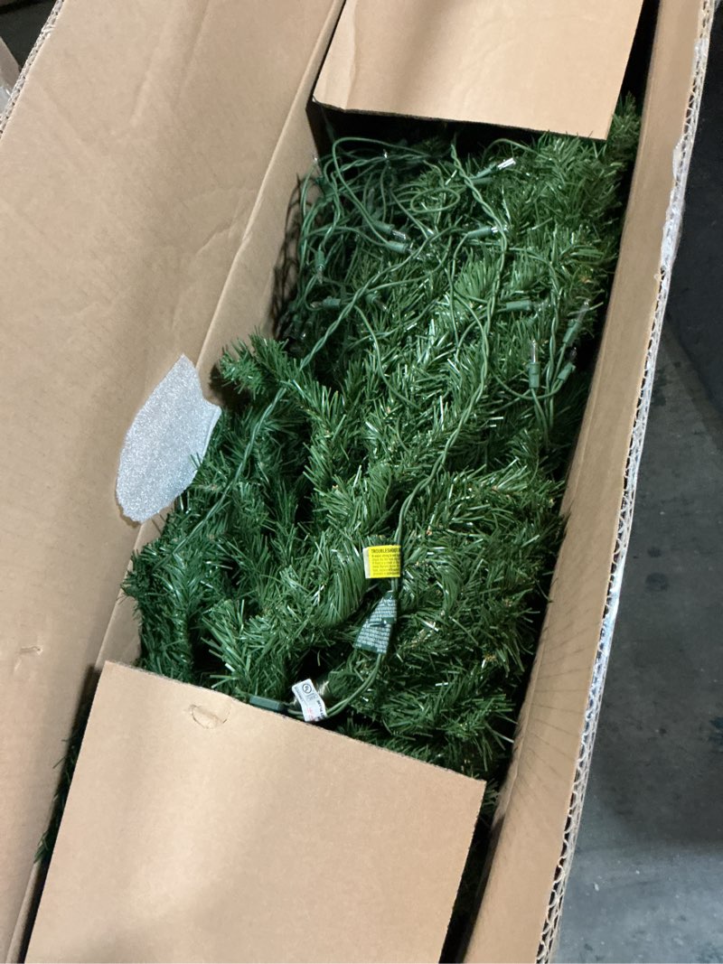 Condition photo showing item condition for National Tree Company Pre-Lit Artificial Slim Christmas Tree, Green, North Valley Spruce, White Lights, Includes Stand, 7 Feet