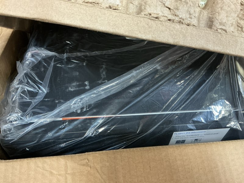 Condition photo showing As Is for mainstays 0.7 cu ft countertop microwave oven, 700 watts, black