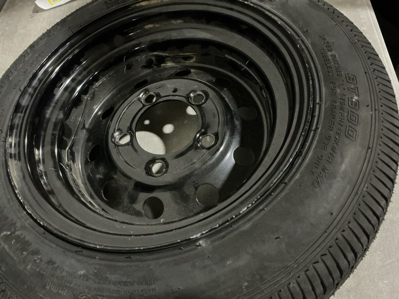 Condition photo showing As Is for donut tire wheel