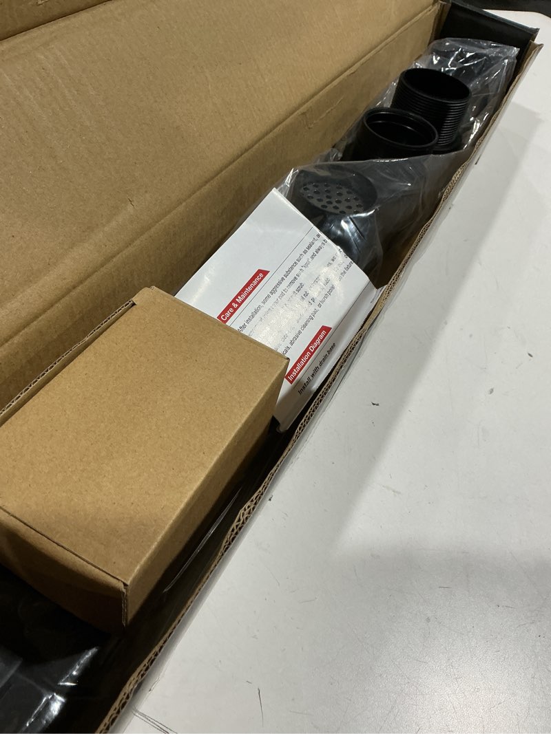 Condition photo showing As Is for EXF Linear Shower Drain 28 Inch Matte Black with Reversible Flat & Tile Insert Cover, Stainless Steel Rectangle Shower Floor Drain with Hair Catcher, Adjustable Feet Matte Black 28 IN